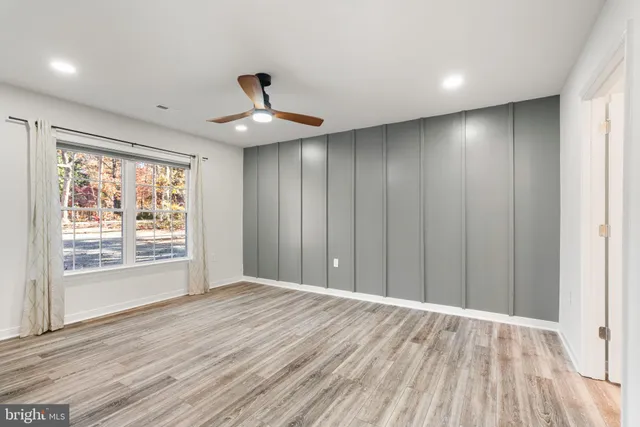 a bathroom with a granite countertop sink a mirror and vanity