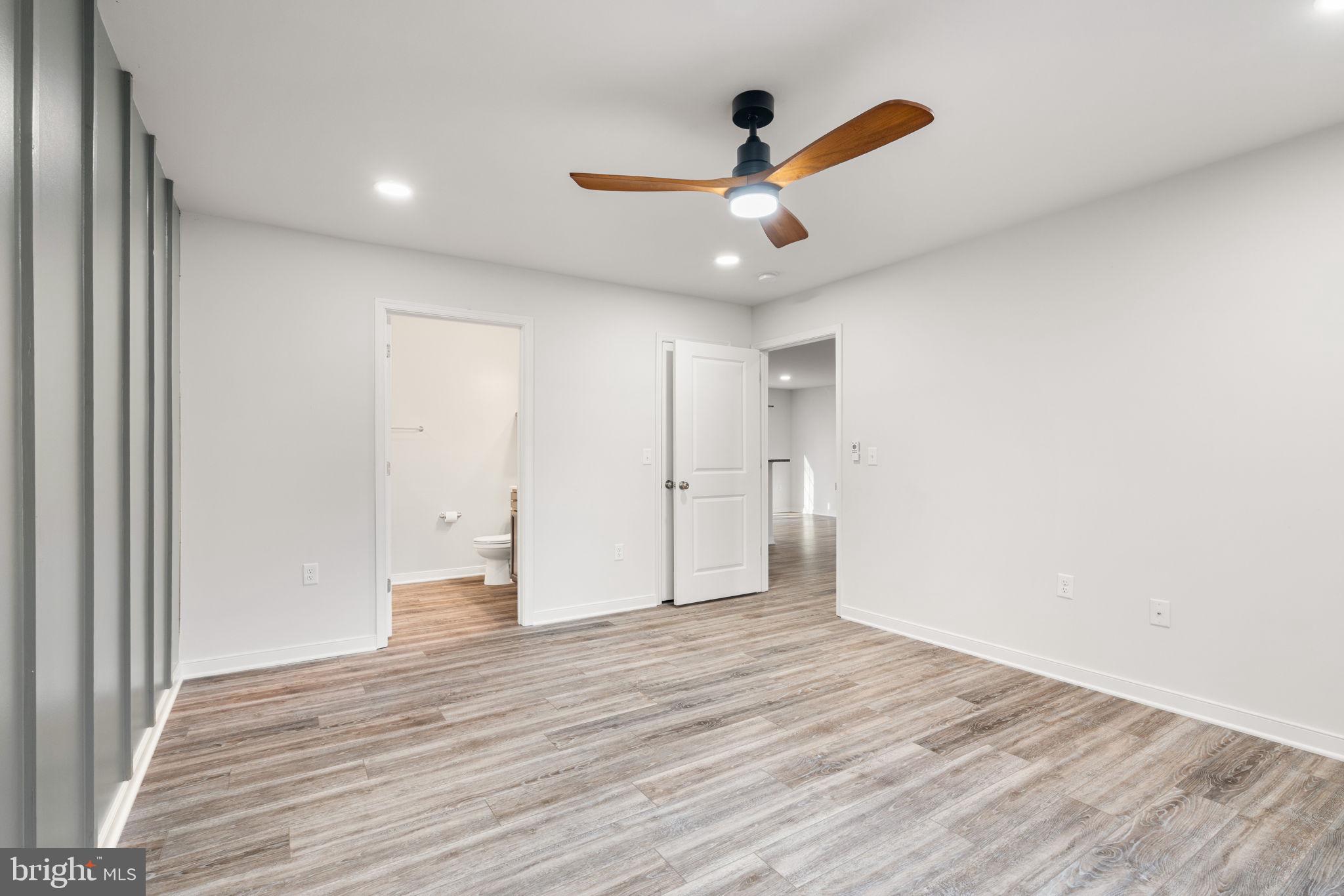 55 Cedar Circle Mineral, VA 23117 - Photo 26 of 44 an empty room with wooden floor ceiling fan and windows