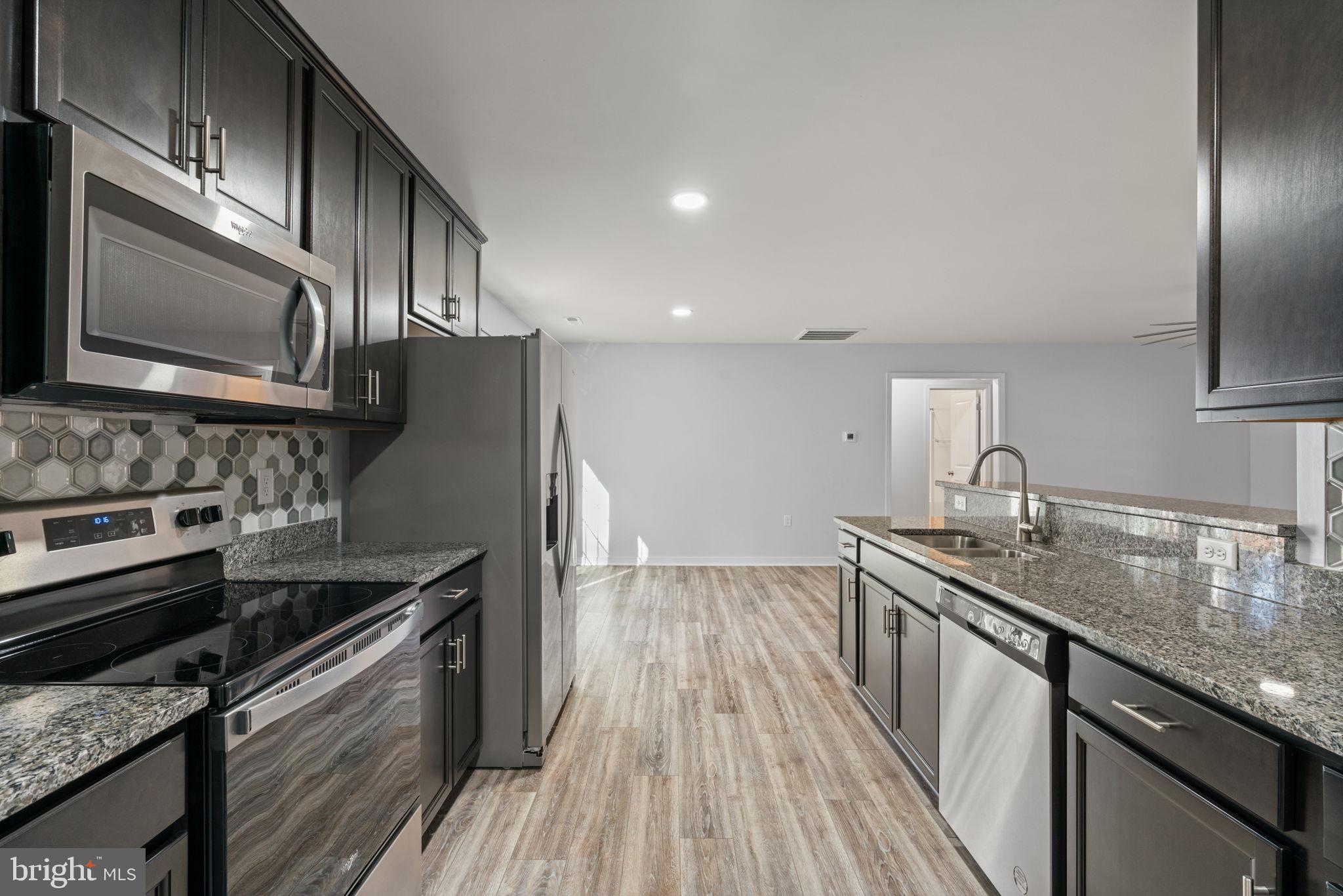55 Cedar Circle Mineral, VA 23117 - Photo 2 of 44 a kitchen with stainless steel appliances granite countertop a sink stove and microwave