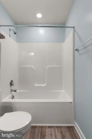 a bathroom with a sink a toilet a mirror and vanity