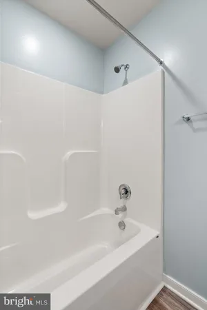 a bathroom with a granite countertop toilet sink and mirror