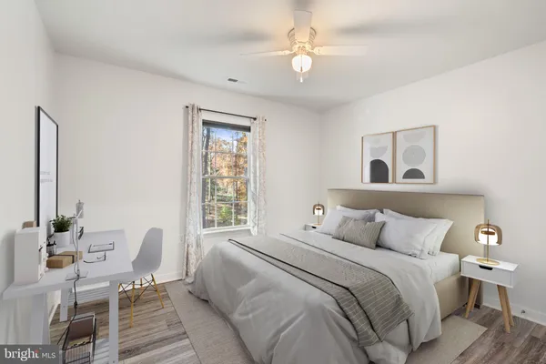 a bedroom with a large bed and a window