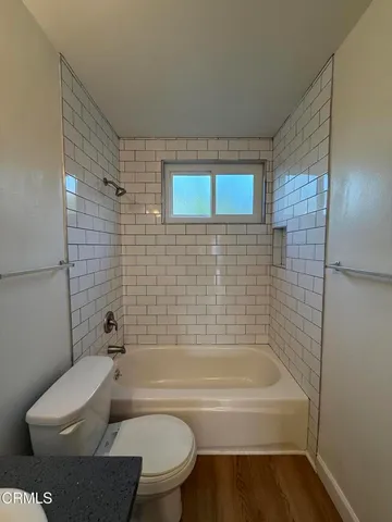 a bathroom with a toilet and bathtub
