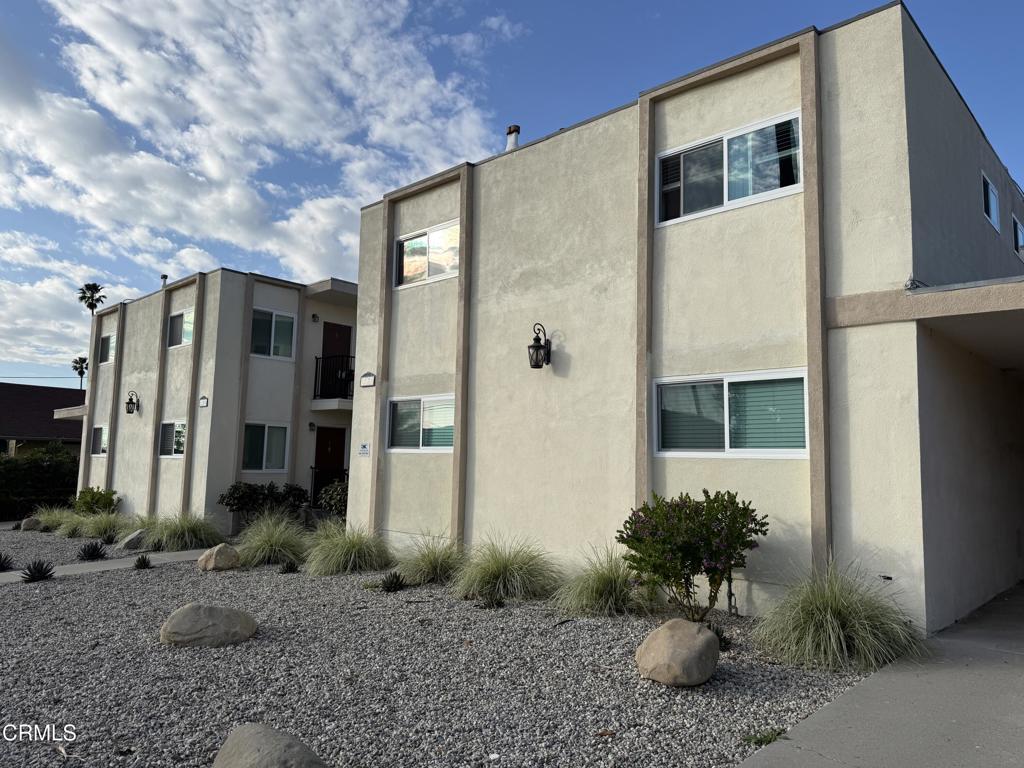 1171 Meta Street, Unit 16 Ventura, CA 93001 - Photo 2 of 15 a backyard of a house with plants and outdoor seating