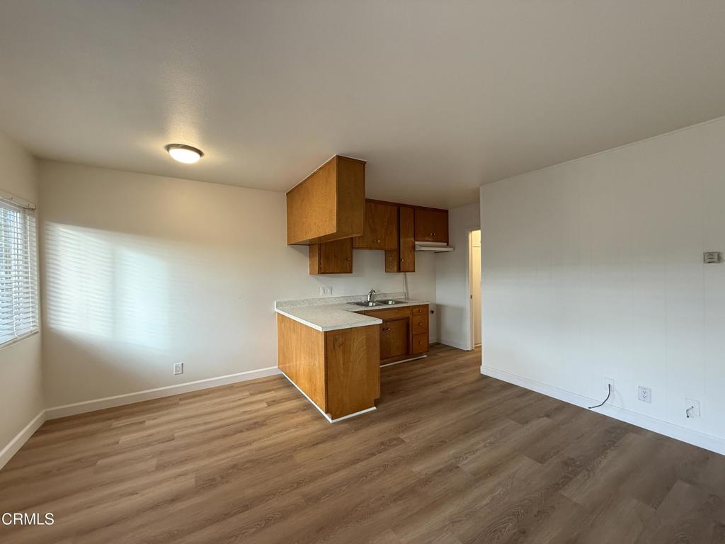 1171 Meta Street, Unit 16 Ventura, CA 93001 - Photo 6 of 15 a kitchen with stainless steel appliances wooden cabinets and a wooden floor
