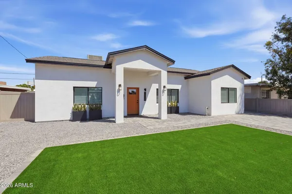 a view of a house with a yard and garage