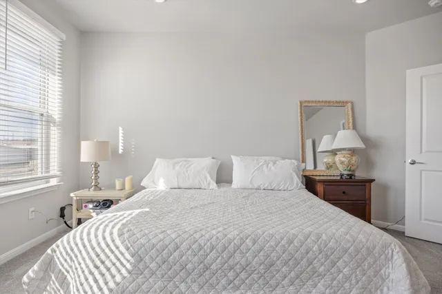 a bedroom with a bed and window