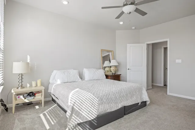 a bedroom with a bed and a lamp