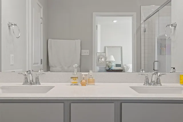 a bathroom with double sink and a mirror