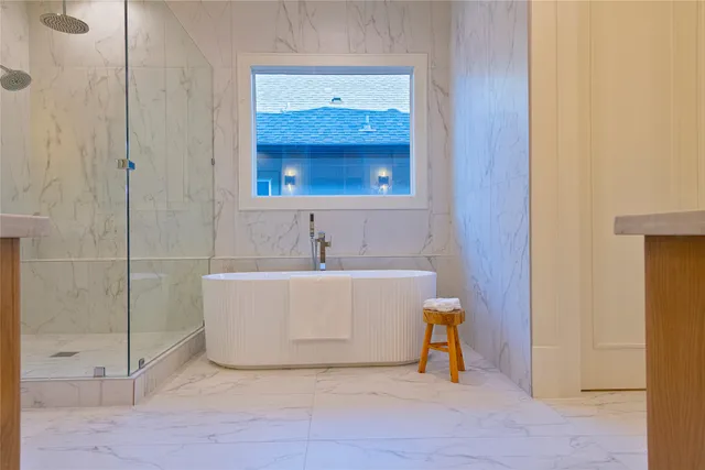 a bathroom with a bathtub and a shower
