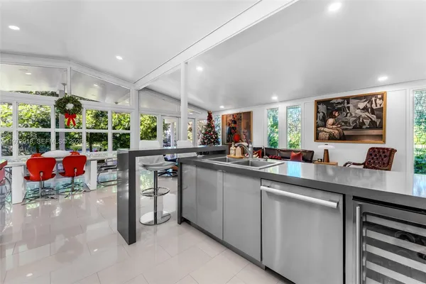 a kitchen with stainless steel appliances kitchen island granite countertop a sink and cabinets