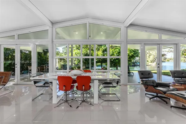 a living room with patio furniture and a large window