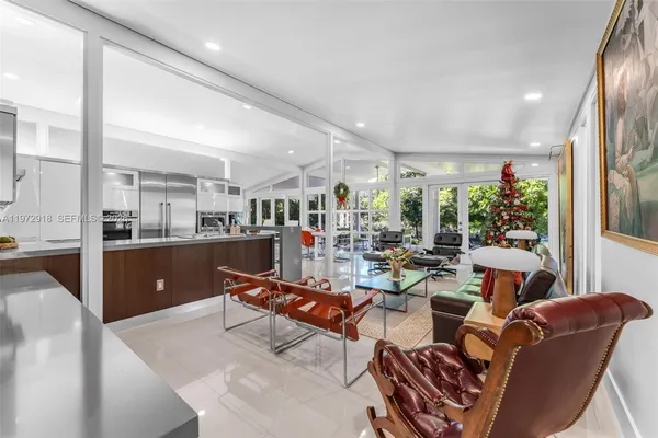 a living room with lots of furniture and a large window