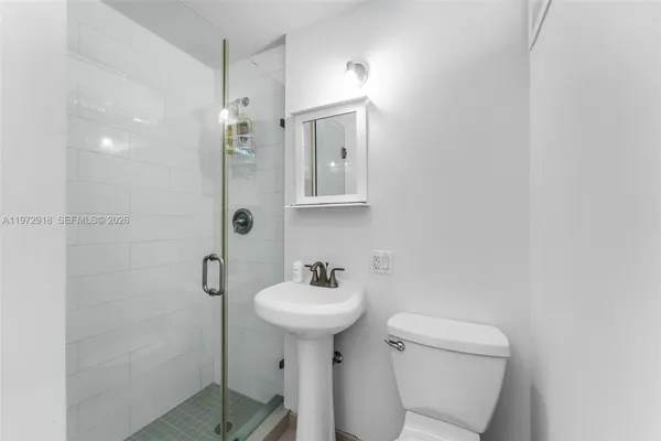 a bathroom with a sink a mirror and a toilet