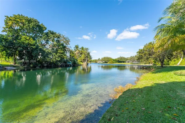 a view of a lake with houses in the background
