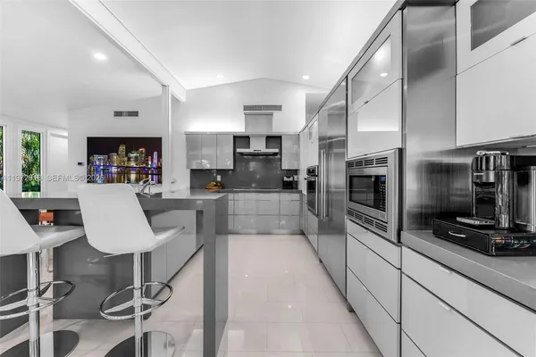 a kitchen with cabinets and chairs