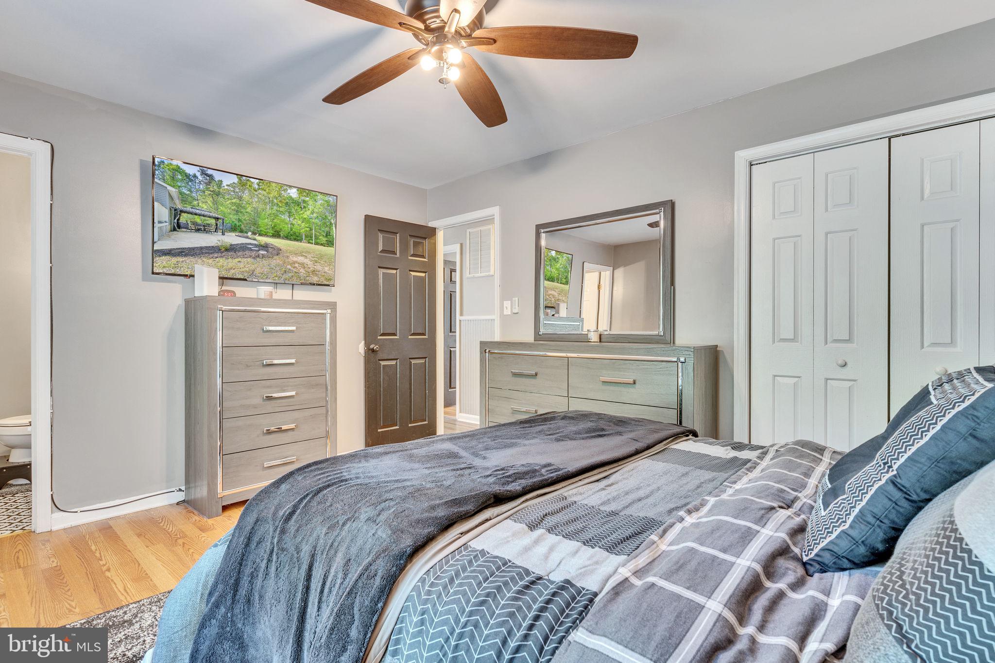 1195 Ball Road Port Republic, MD 20676 - Photo 14 of 23 a bedroom with a bed and a chandelier