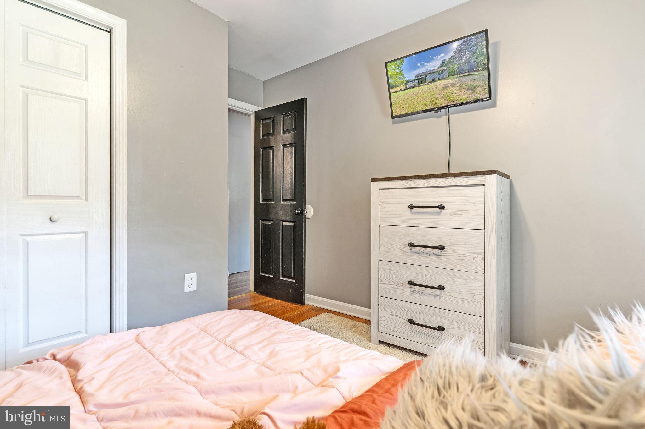 1195 Ball Road Port Republic, MD 20676 - Photo 17 of 23 a bedroom with a bed and a painting on the wall