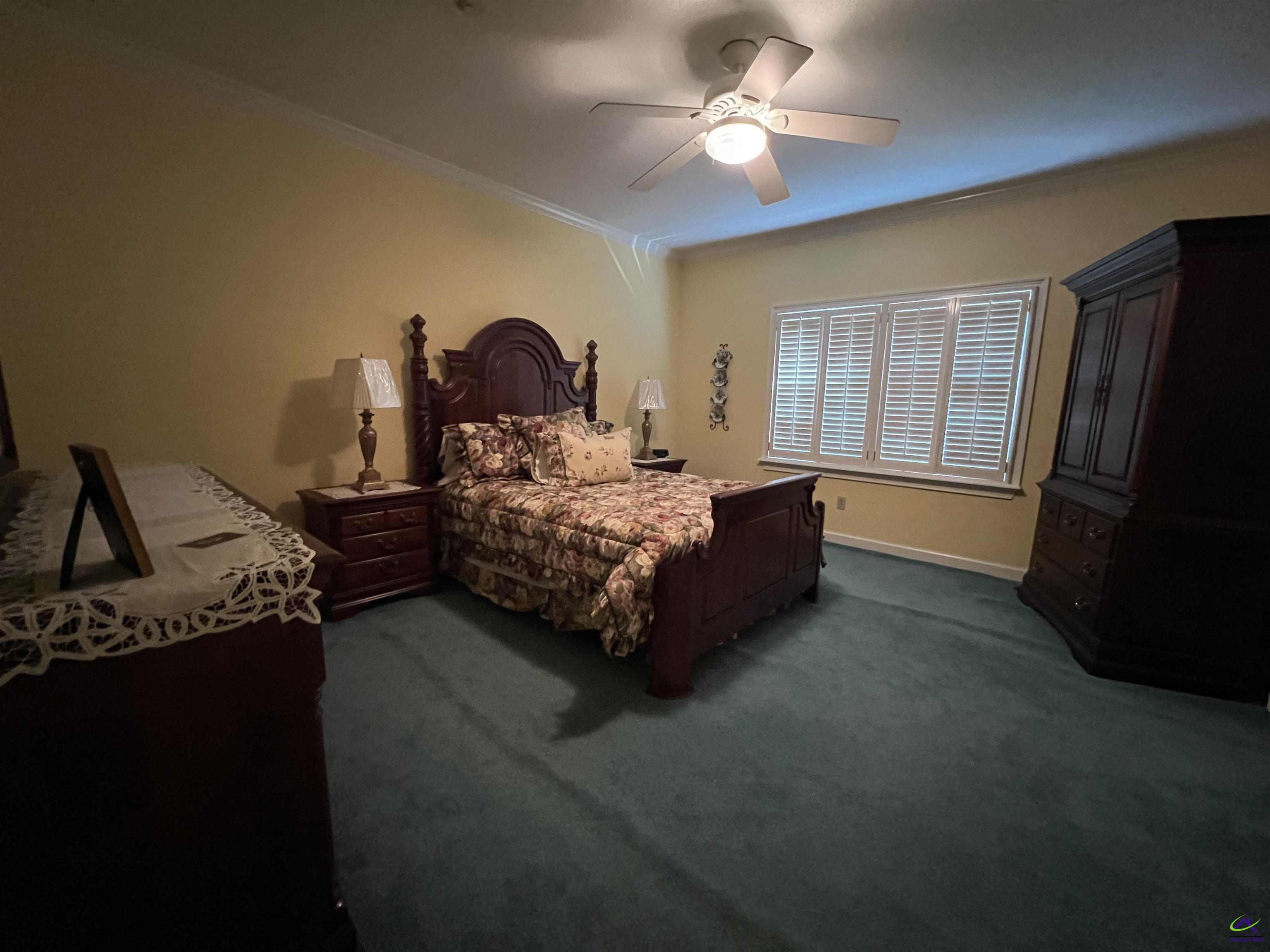 762 Nicholson-Carr Road Chester, GA 31012 - Photo 24 of 81 a bed room with a bed furniture and a flat tv screen