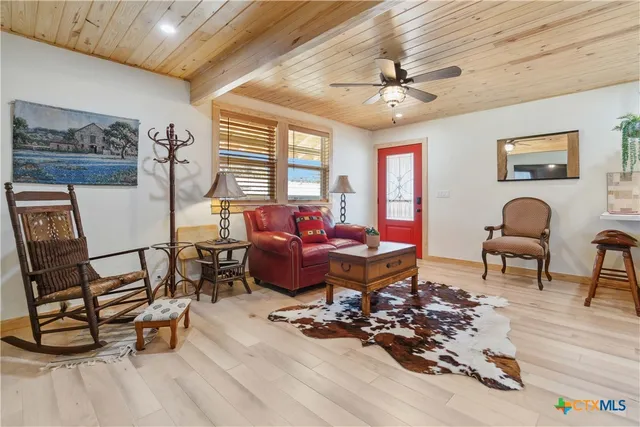 a view of a dining room with furniture and a window
