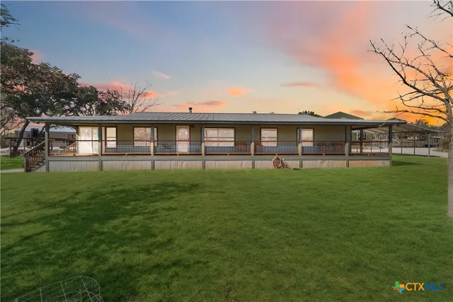 a kitchen with stainless steel appliances granite countertop a sink and a refrigerator