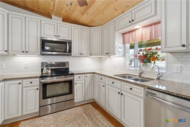 a kitchen with a sink cabinets and window