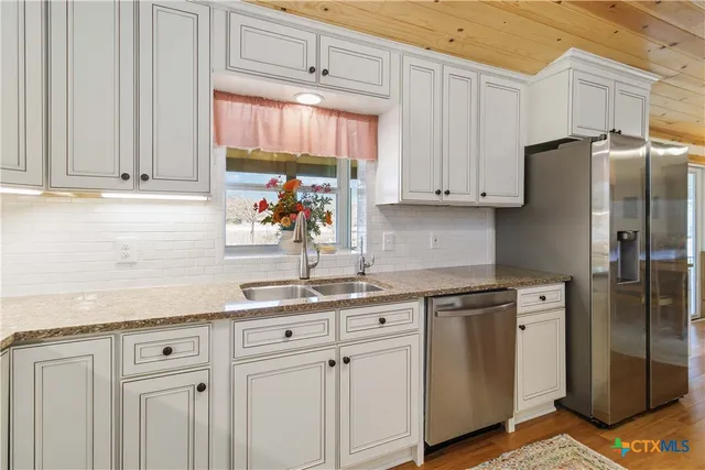 a living room with furniture and a dining table