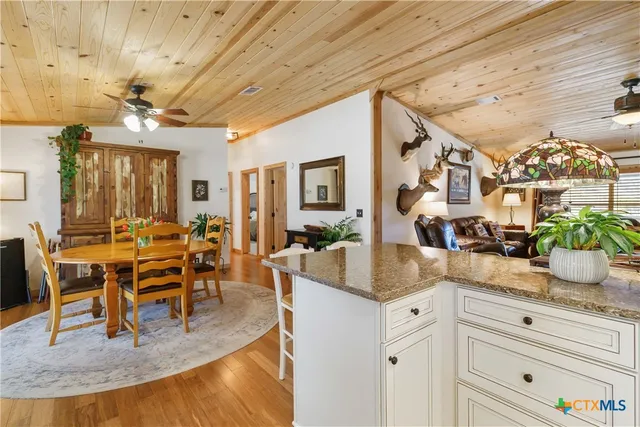 a spacious bedroom with a bed a couch and a chandelier