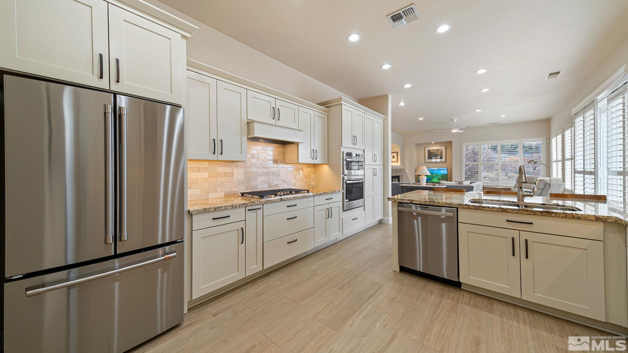 2085 Tesuque Court Reno, NV 89511 - Photo 22 of 40 a kitchen with granite countertop white cabinets and white appliances