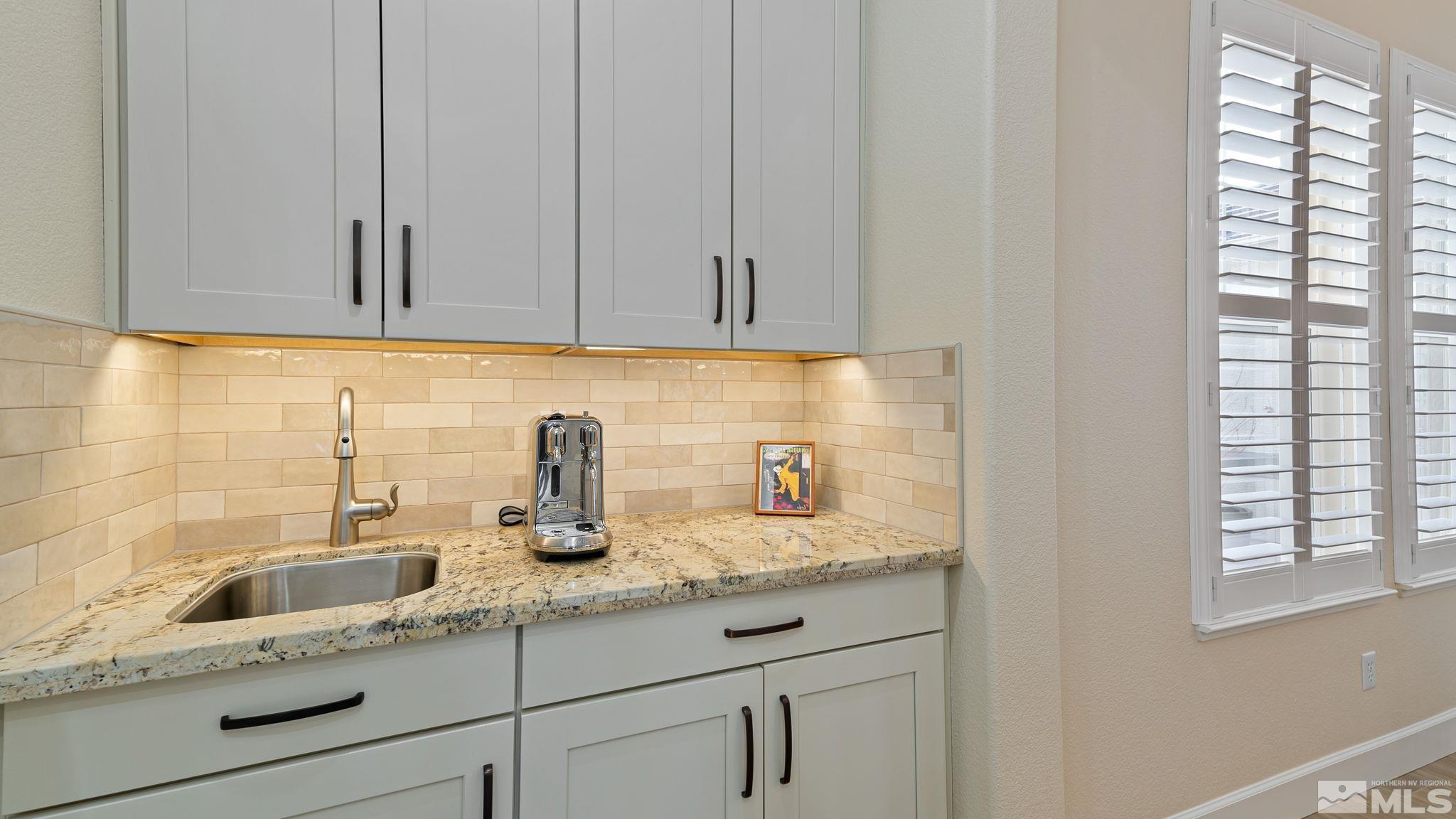 2085 Tesuque Court Reno, NV 89511 - Photo 23 of 40 a kitchen with granite countertop white cabinets and a sink
