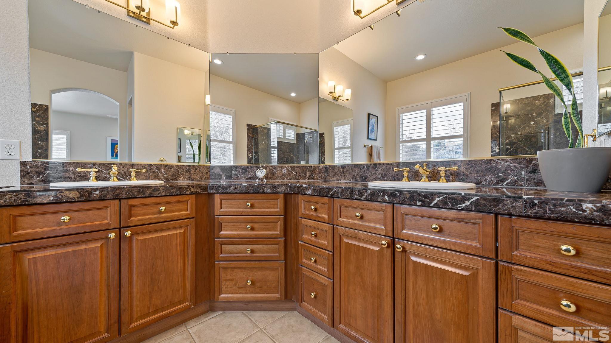 2085 Tesuque Court Reno, NV 89511 - Photo 29 of 40 a sink with granite countertop a double vanity sink and a large mirror
