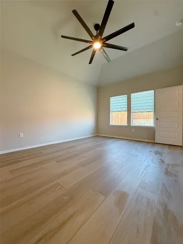 a view of a livingroom with a ceiling fan and window