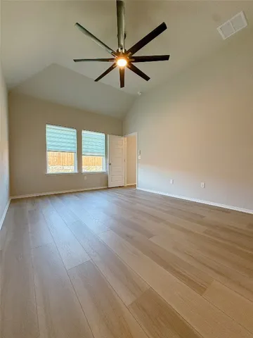 an empty room with windows and closet