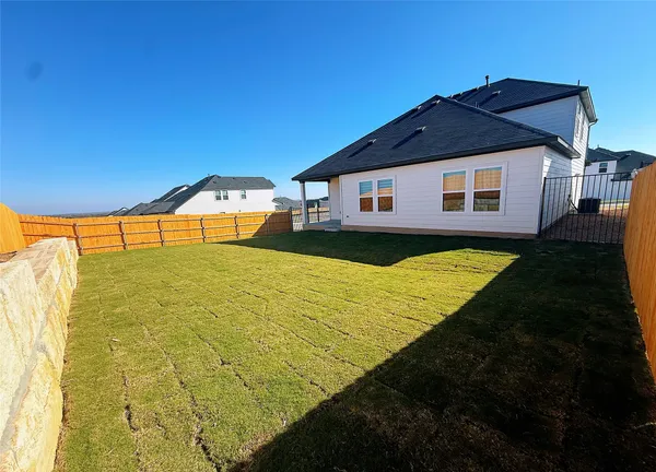 a front view of house with yard and patio