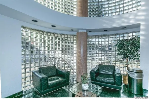 a living room with furniture and a floor to ceiling window