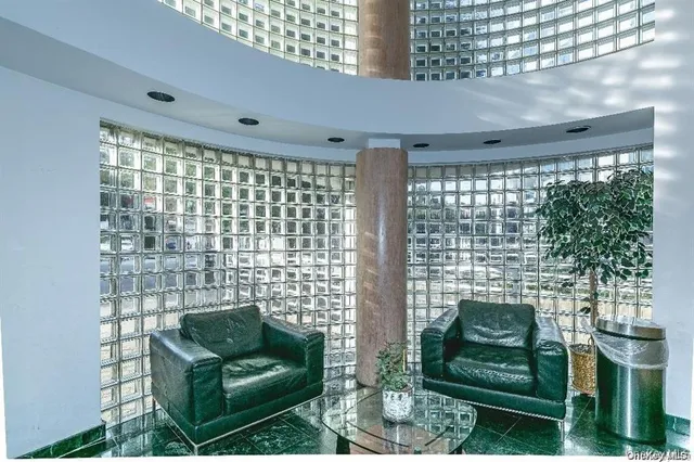 a living room with furniture and a floor to ceiling window