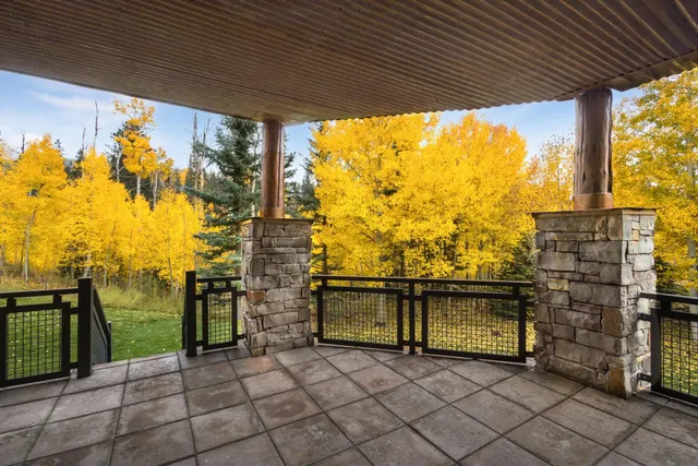 a view of a patio with table and chairs with wooden floor and fence