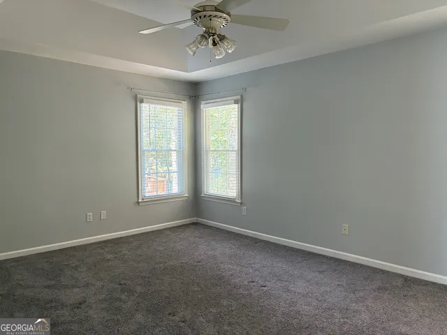 a view of room with window and ceiling fan