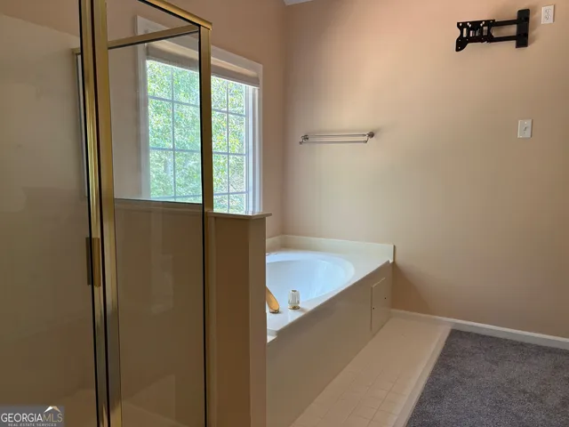 a bathroom with a tub and shower