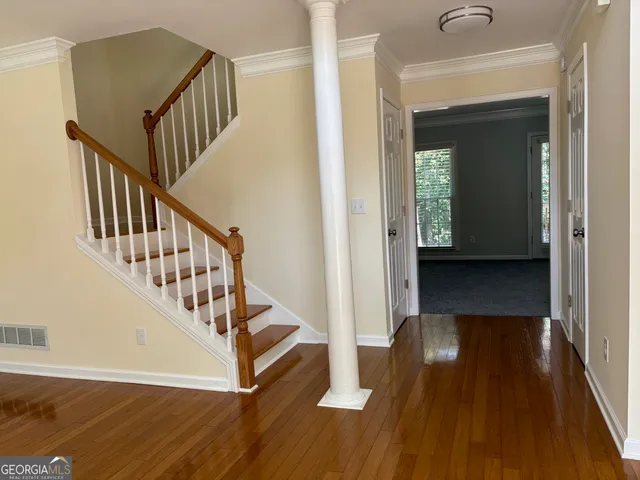 a view of entryway with wooden floor and stairs