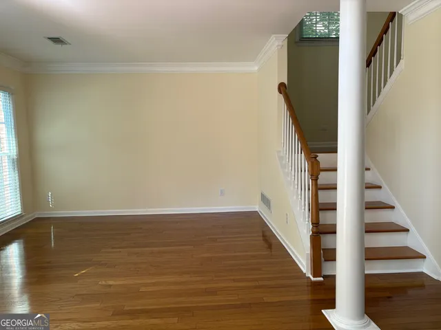 a view of an entryway with wooden floor