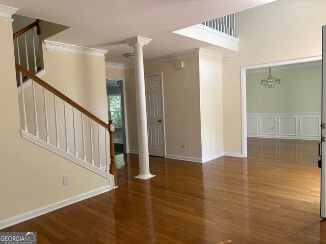 a view of a hallway view with wooden floor and staircase