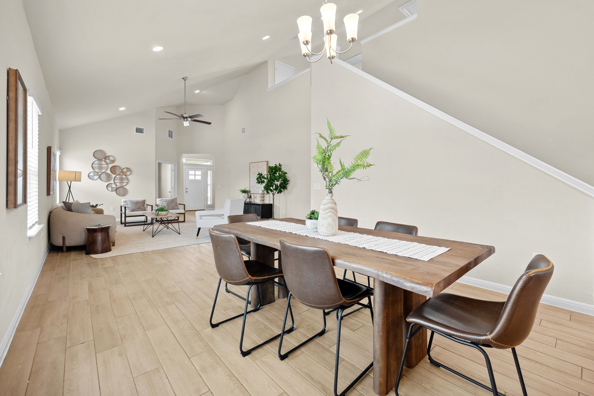 2413 Starhill Ranch Street Georgetown, TX 78628 - Photo 13 of 40 a view of a dining room with furniture and wooden floor