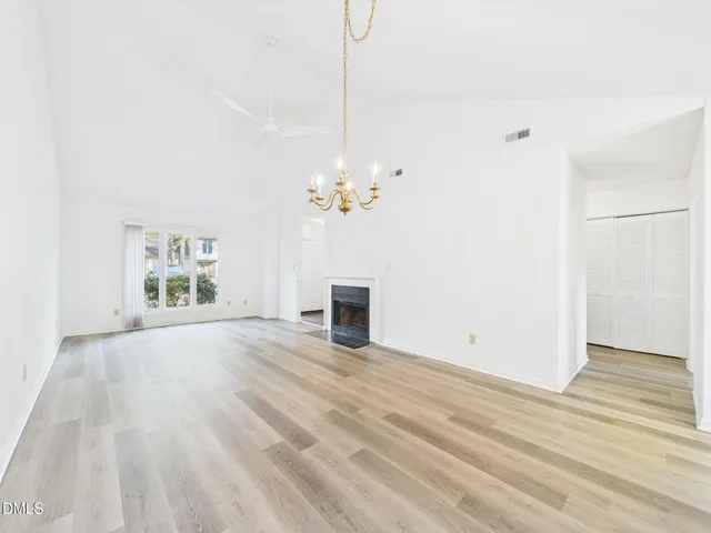 a view of a room with wooden floor and window