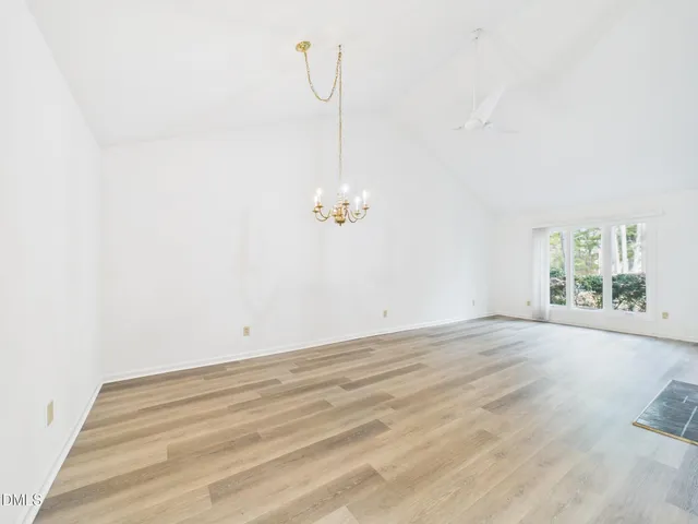 a view of a room with wooden floor and window
