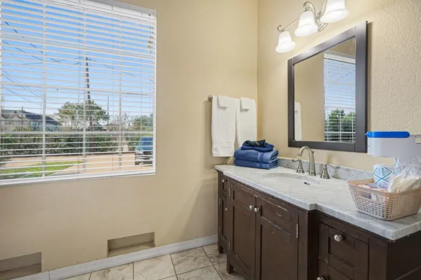 a spacious bathroom with a tub sink shower and mirror