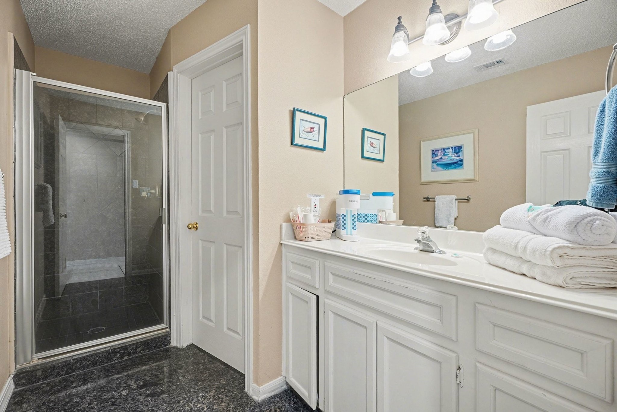 503 Bay Avenue Kemah, TX 77565 - Photo 17 of 47 a en suite bathroom with a sink mirror and a shower