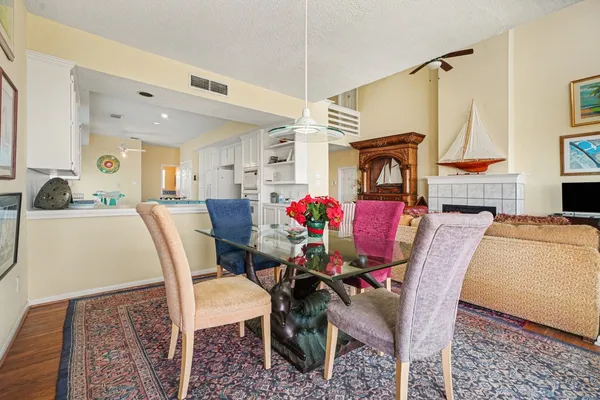 a kitchen with kitchen island a stove a sink a refrigerator and cabinets