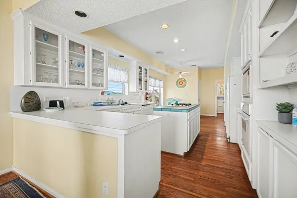 a kitchen with stainless steel appliances a sink a stove a refrigerator cabinets and a counter top space