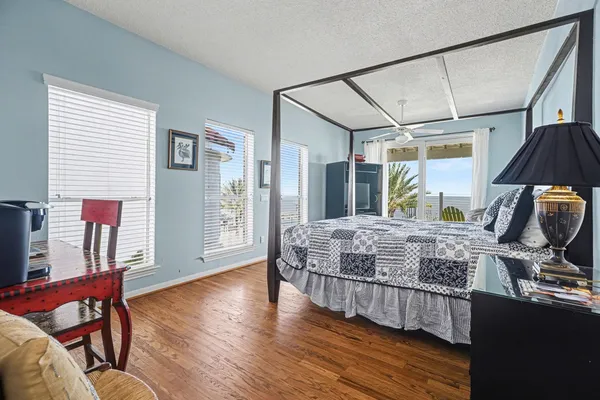 a bedroom with a bed mirror and a window